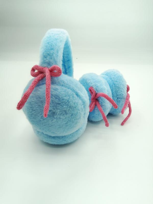Baby blue plush earmuffs with pink knitted bow decorations laid flat on white background - custom packaging design free