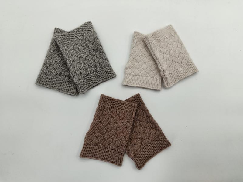 Three pairs of basket weave knit fingerless gloves in grey, cream beige, and brown laid flat on white background - retail buyer inquiry welcome - EU REACH compliant material