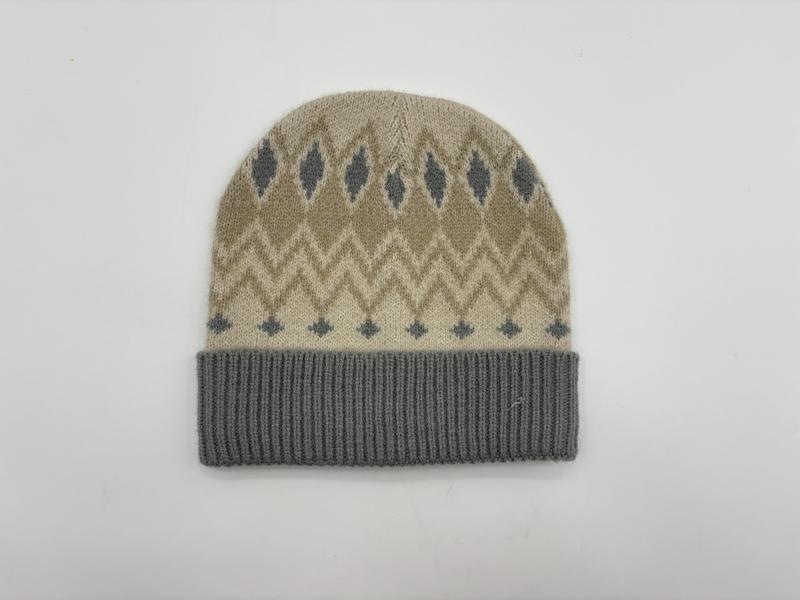 Beige knit beanie hat with grey Fair Isle diamond and chevron pattern and grey ribbed cuff, flat lay on white background - email us get price list now