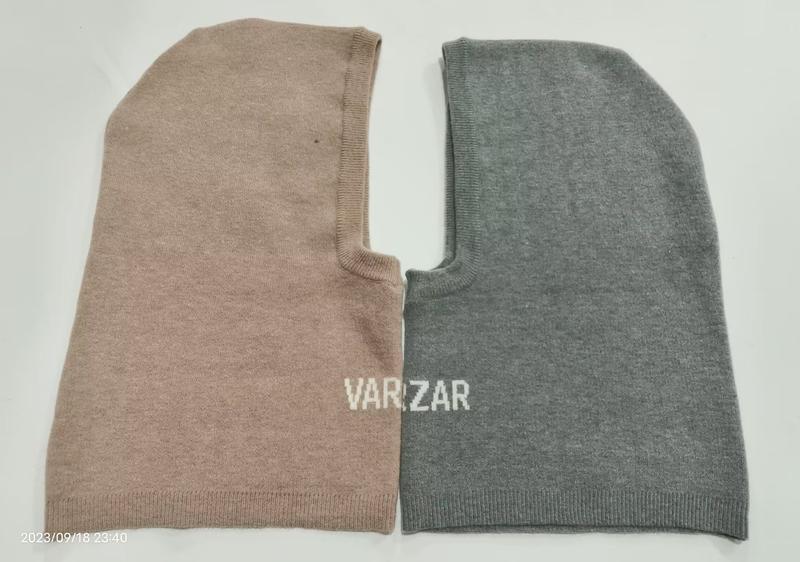 Two knitted balaclava ski masks laid flat, one in beige and one in grey, both with face opening and ribbed edges, branded VARIZAR - no MOQ for stock designs