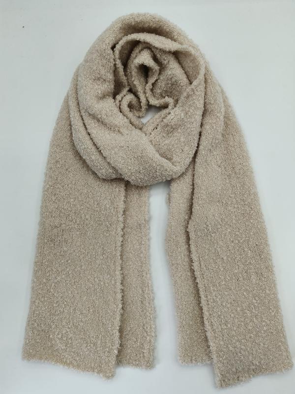 Oversized beige boucle knit scarf loosely wrapped and laid flat on white background - low MOQ 50pcs trial order
