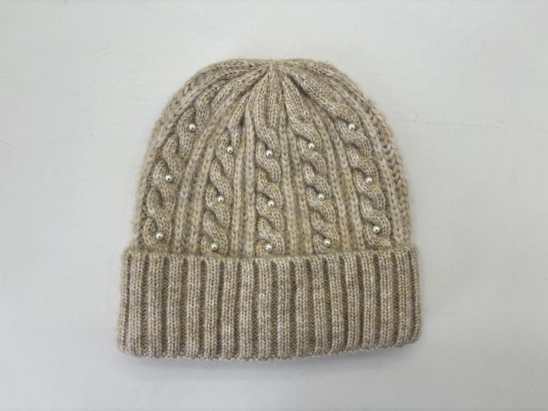 Beige cable knit winter beanie hat with pearl bead embellishments and ribbed cuff, flat lay on white background - hotel amenity scarf supplier