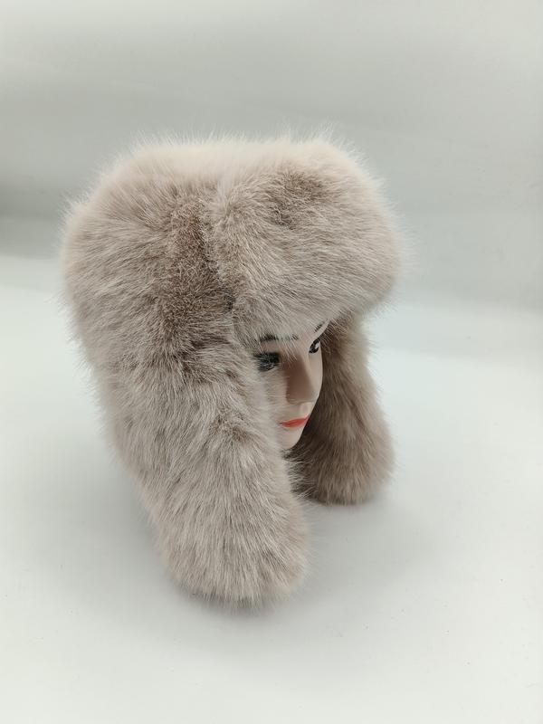 Fluffy beige faux fur trapper ushanka hat with long ear flaps displayed on a mannequin head against white background - EU REACH compliant material