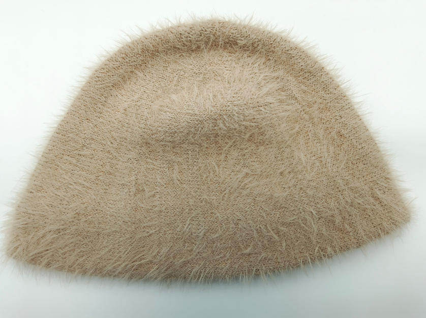 Beige fluffy eyelash knit bucket hat with soft furry texture, laid flat on white background - gift shop wholesale supplier