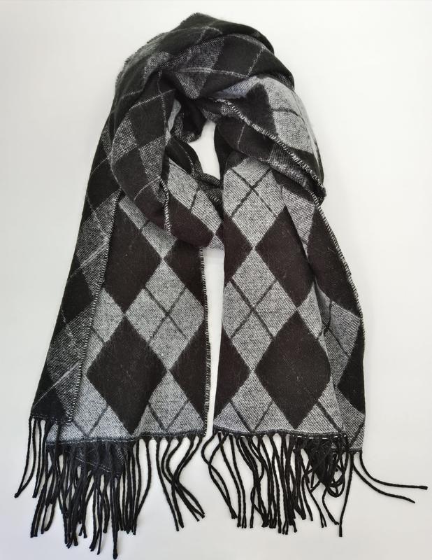 Black and grey argyle diamond pattern woven scarf with black fringe tassels, looped and laid flat on white background - bulk order 20-day delivery