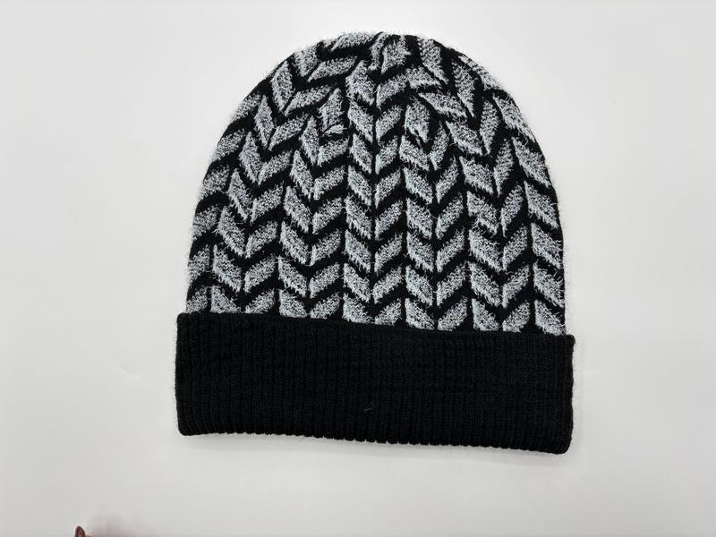 Black and grey chevron herringbone pattern knit beanie hat with solid black ribbed cuff, laid flat on white background - hotel amenity scarf supplier