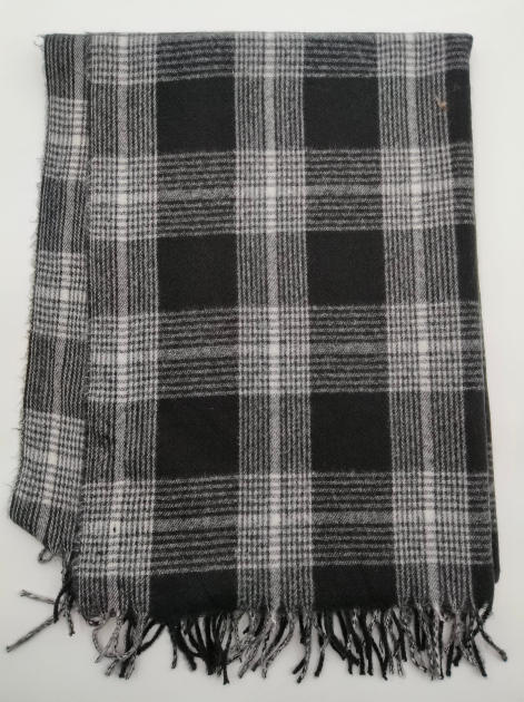 Folded black and white tartan plaid woven throw blanket with knotted fringe trim on white background - contact for custom design quote