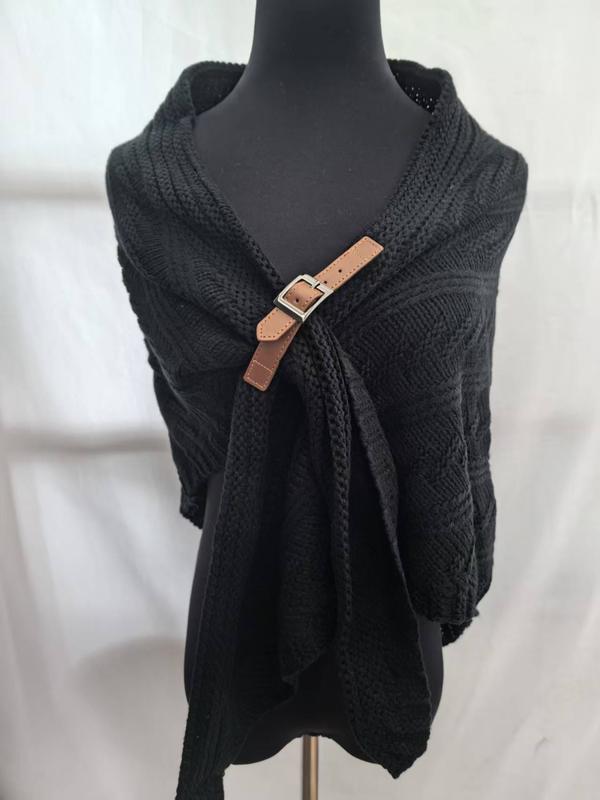 Black cable knit wrap shawl displayed on mannequin, fastened with a tan leather buckle clasp at the chest - contact for custom design quote