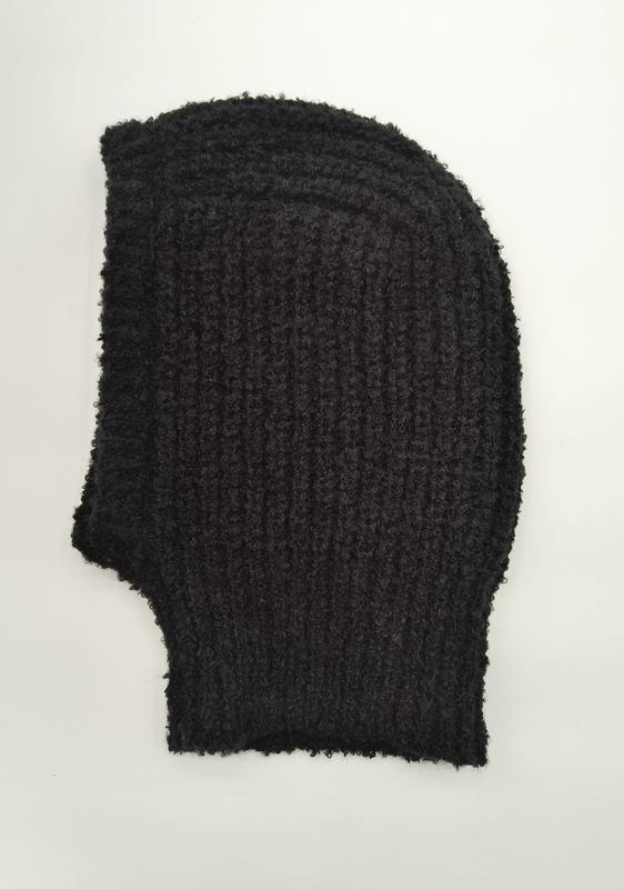 Black chunky ribbed knit balaclava laid flat on white background, bouclé textured wool full face mask with frayed edges - factory direct price no middleman