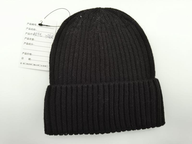 Black chunky ribbed knit beanie hat with folded cuff brim and product tag, flat lay on white background - BSCI audit passed supplier