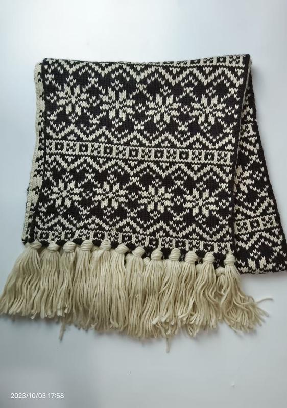 Folded black and cream Fair Isle knitted scarf with geometric snowflake pattern and long cream tassel fringe along bottom edge - bulk order 500+ pcs extra 8% off