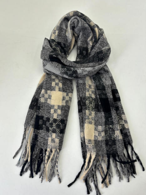 Folded woven scarf in black, grey and cream patchwork check pattern with tassel fringe ends on white background - custom packaging design free