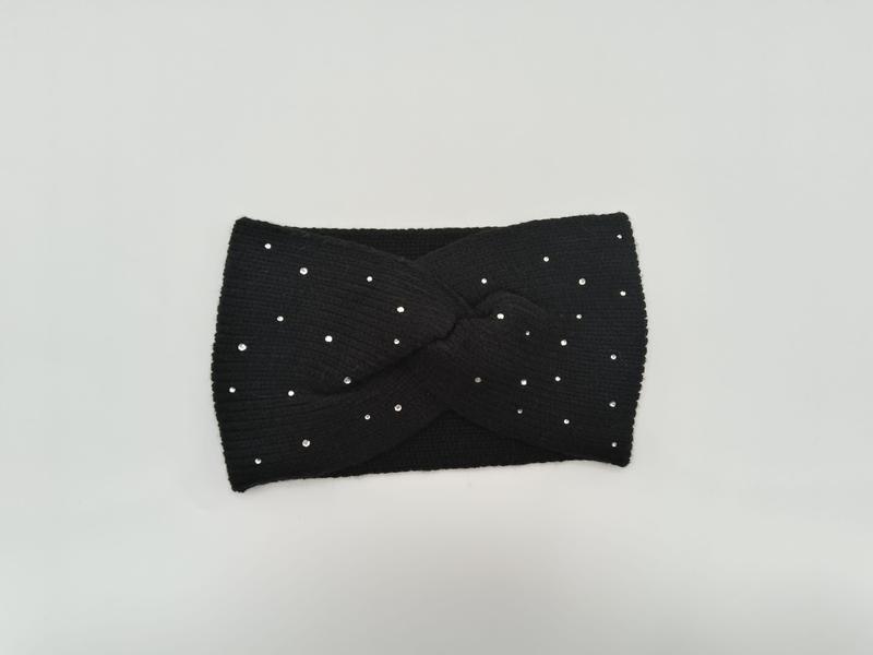 Black ribbed knit twist headband with scattered silver crystal rhinestone studs laid flat on white background - BSCI audit passed supplier