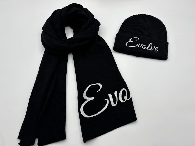 Black ribbed knit winter scarf and beanie hat set with white embroidered cursive text on white background - tiered pricing available ask quote