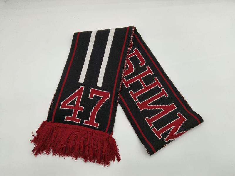 Black knitted sports fan scarf with red and white stripes, number 47, bold lettering, and red fringe tassels on white background - wholesale price for Europe buyers