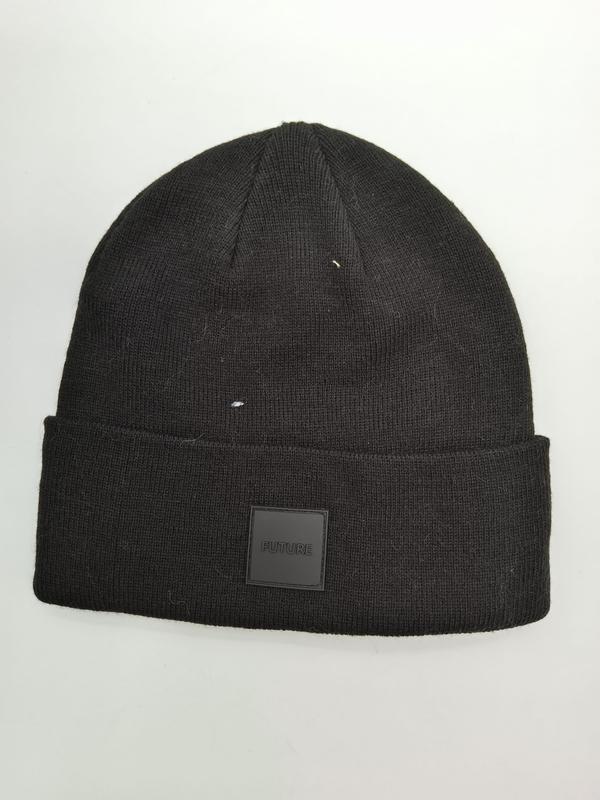 Black ribbed knit beanie hat with folded cuff and square FUTURE rubber patch label on white background - small batch 100pcs accepted