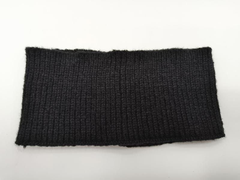 Close-up of a black ribbed knit fabric swatch with vertical rib texture, shown flat on white background - ODM OEM service available - bulk order 20-day delivery
