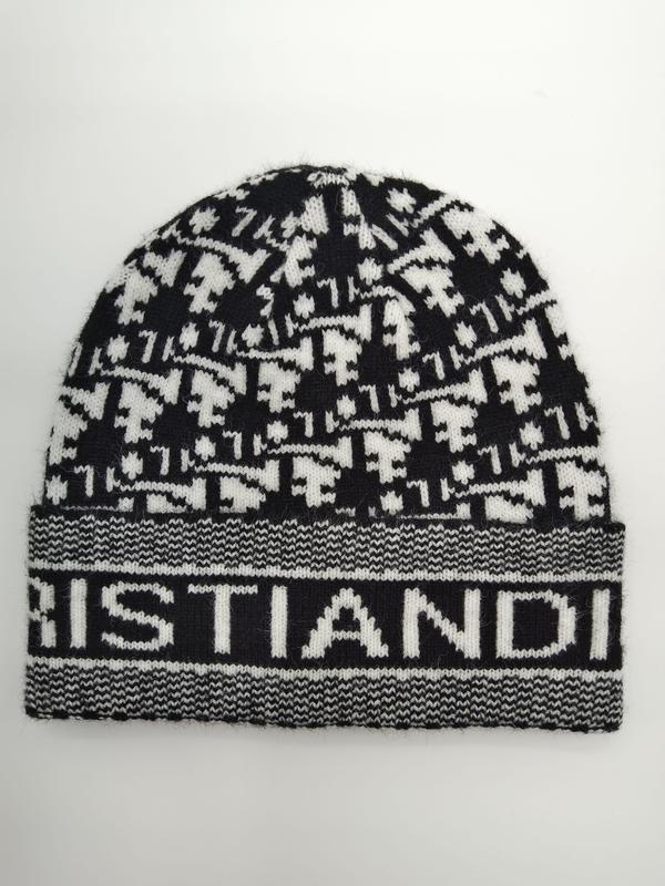 Black and white houndstooth patterned knit beanie with ribbed logo cuff band, laid flat on white background - custom logo label accepted