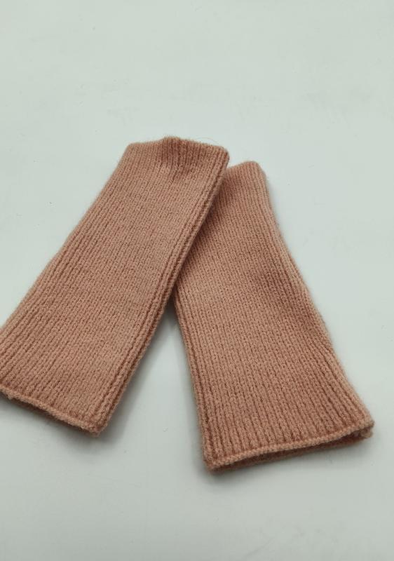 Pair of blush pink ribbed knit fingerless gloves wrist warmers laid flat on white background - ISO 9001 quality controlled