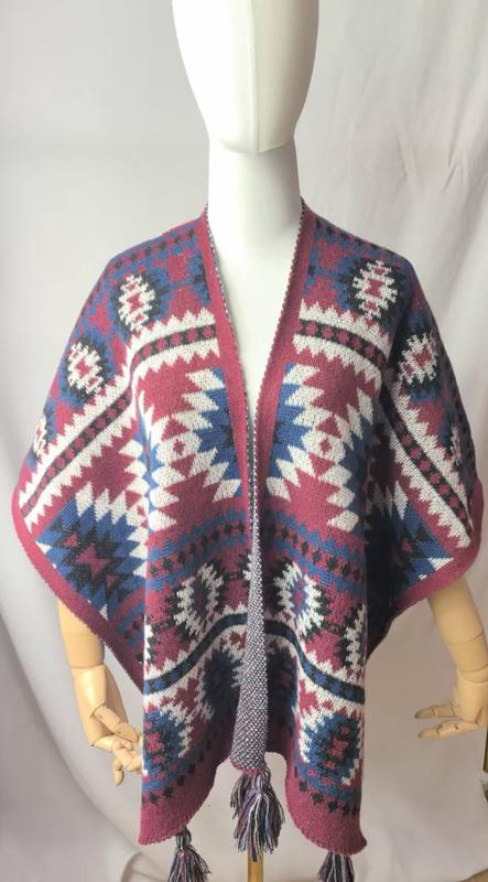 Mannequin wearing open-front knit poncho with Aztec geometric pattern in burgundy, blue, white, and black with tassel trim - small batch 100pcs accepted