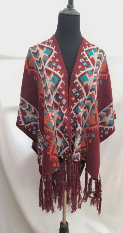 Burgundy knit poncho with multicolor Aztec geometric pattern in teal orange and white displayed on dress form with tassel fringe hem - sample order 10pcs available