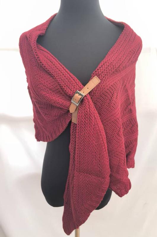 Burgundy chunky knit wrap shawl secured with a tan leather buckle clasp, draped on a mannequin torso - wholesale price for Europe buyers
