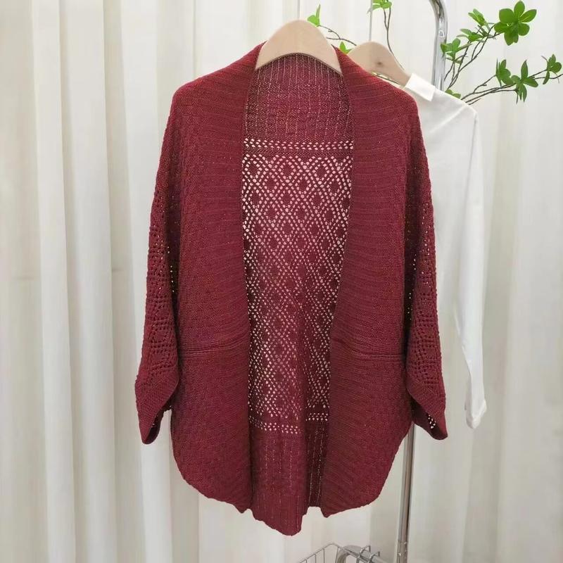 Burgundy knit open-front cardigan with diamond crochet lace back panel and 3/4 sleeves hanging on a rack - express production 15 days