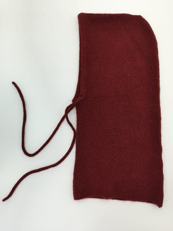 Deep red ribbed knit balaclava hood laid flat on white background with two long tie strings on the left side - jacquard custom pattern accepted