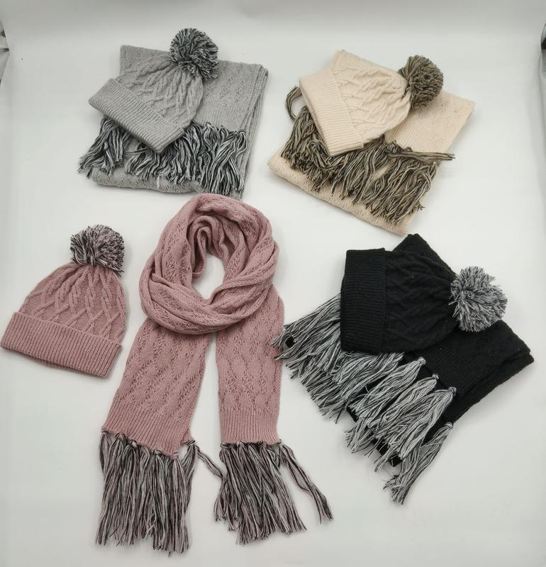 Four cable knit hat and scarf sets in grey, beige, pink, and black with pom pom beanies and tassel fringe scarves - ask bulk pricing get discount