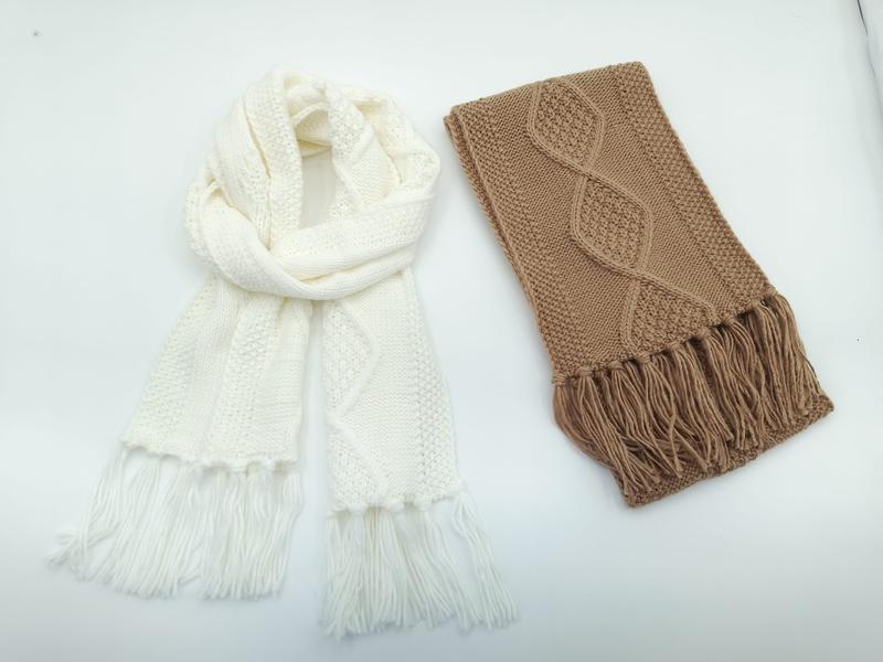 Two cable knit scarves with fringe on white background: one cream infinity scarf draped loosely, one folded camel brown scarf - ODM OEM service available - request quote reply same day