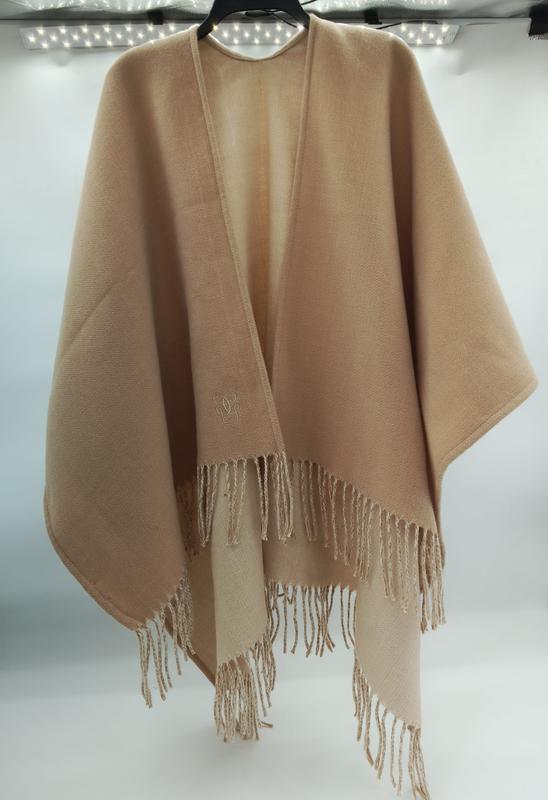 Camel beige open-front wool cape poncho with tassel fringe hem and embroidered monogram logo on hanger - ask bulk pricing get discount