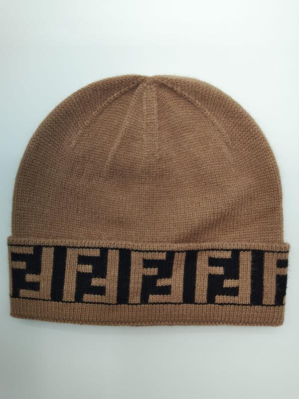 Camel brown fine knit beanie hat with folded cuff featuring repeating black geometric monogram logo pattern - EU REACH compliant material