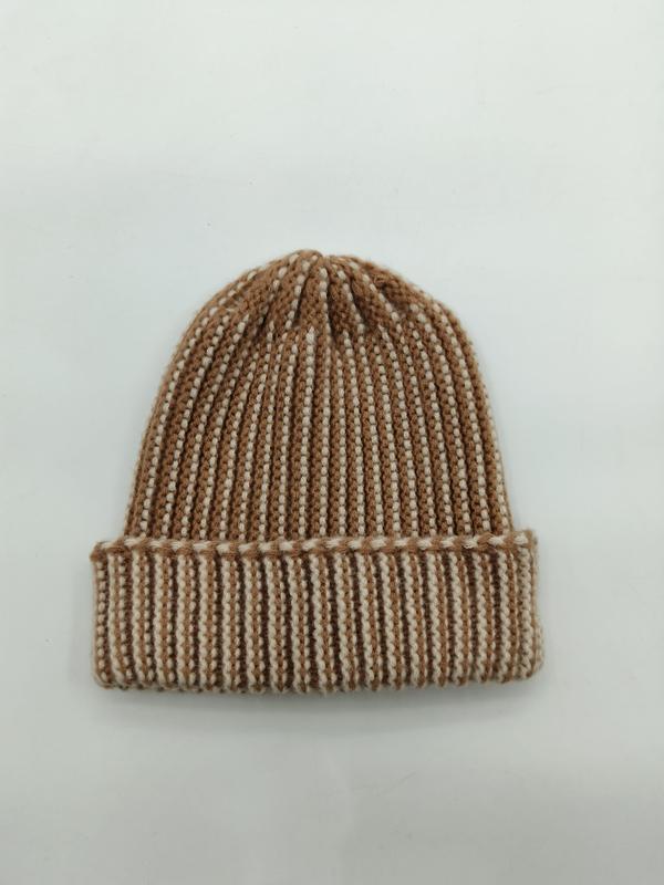 Flat lay of a camel and cream two-tone ribbed knit beanie hat with a folded cuff on a white background - custom logo label accepted