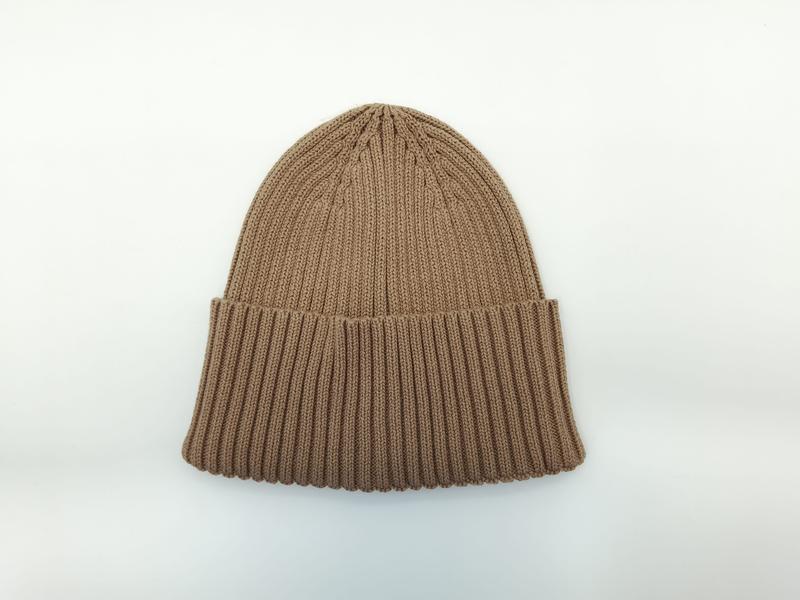 Camel tan chunky ribbed knit cuffed beanie hat laid flat on white background, showing textured stitch detail - custom packaging design free