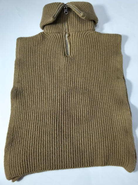 Camel tan ribbed knit sleeveless poncho vest with half-zip collar, laid flat on white background - WhatsApp quote in 2 hours