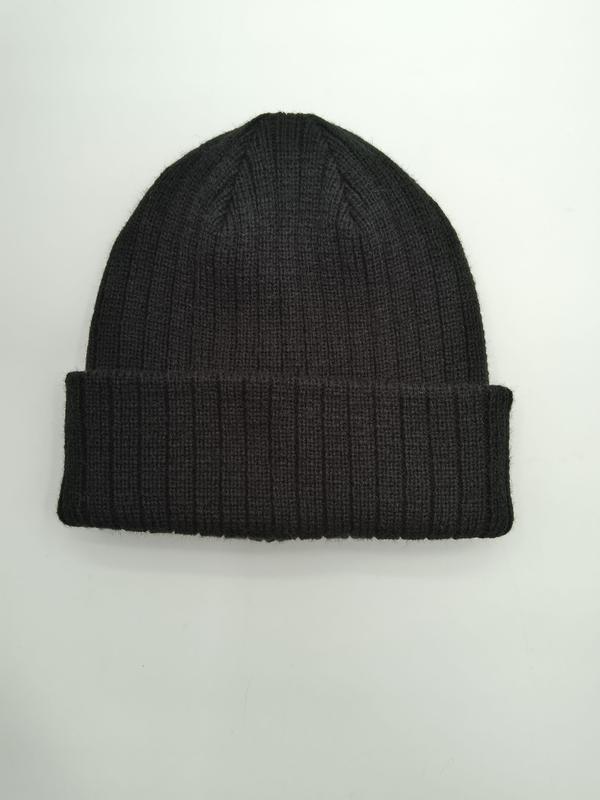 Dark charcoal ribbed knit beanie hat with folded cuff, laid flat on white background, soft wool blend winter hat - private label service available