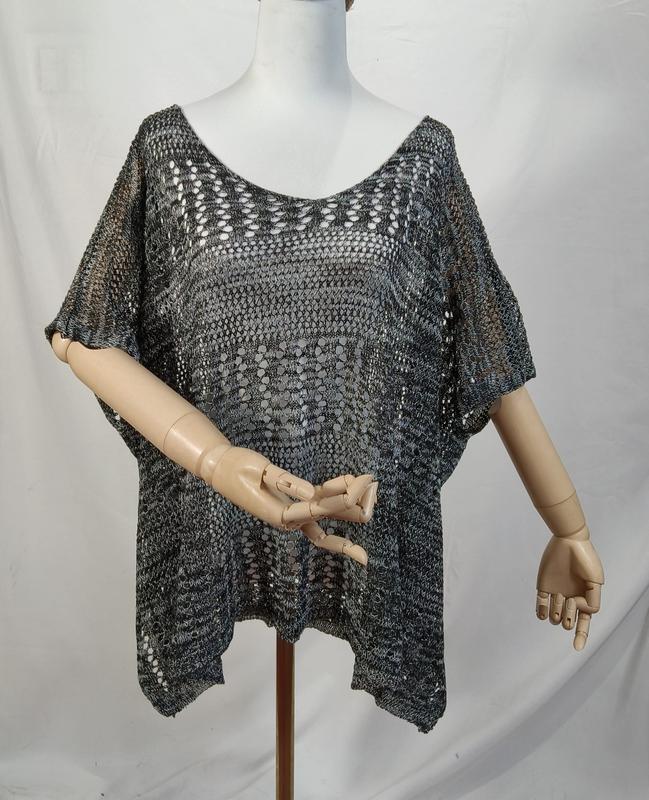 Charcoal grey open-knit crochet poncho top with short sleeves and V-neckline displayed on mannequin - request quote reply same day