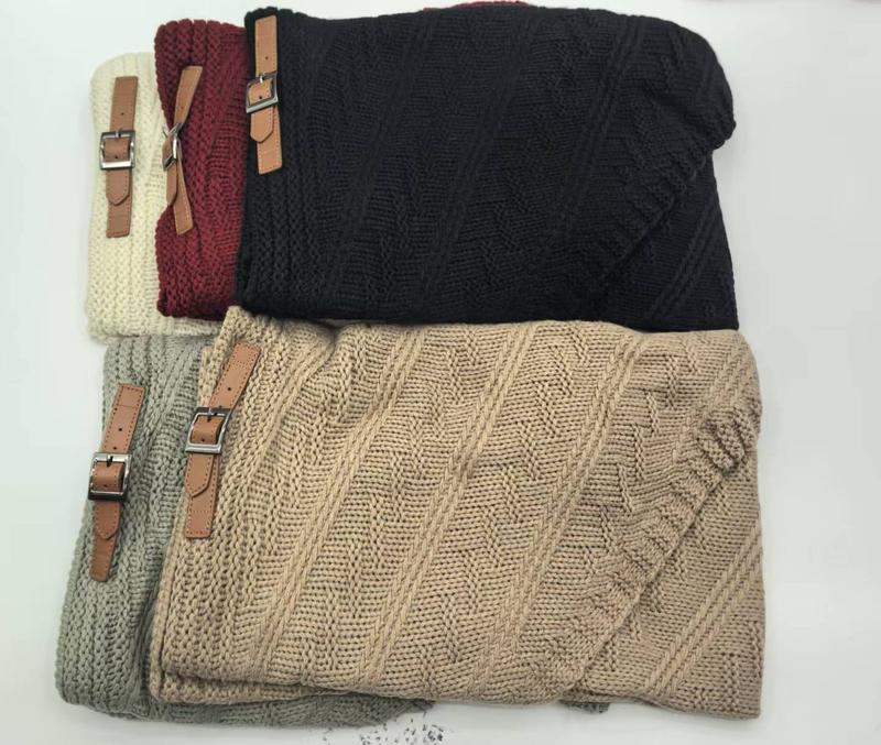 Five folded chunky cable knit throw blankets in beige, grey, black, burgundy, and cream with brown leather buckle straps - certified scarf manufacturer China - email us get price list now