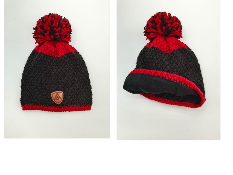 Black and red chunky knit pom-pom beanie with leather logo patch and fleece lining shown front and interior views - 5-day digital sample ready