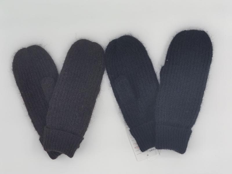 Two pairs of chunky knit mittens in dark charcoal gray and navy blue laid flat on white background with product tag - boutique retail bulk order
