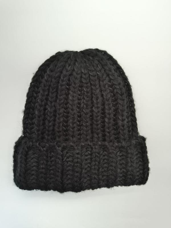 Black chunky ribbed knit beanie hat with folded cuff, photographed flat on white background, handmade style - winter accessories wholesaler