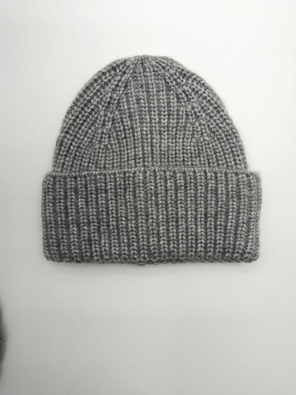 Flat lay of a heather grey chunky ribbed knit beanie hat with folded cuff on white background - corporate gift customization