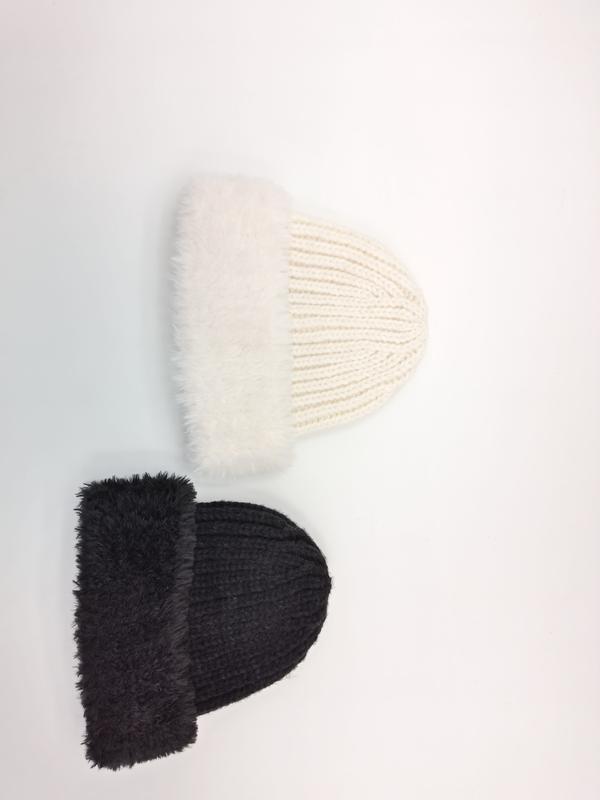Two chunky ribbed knit beanies with fluffy faux fur folded cuff in cream white and dark charcoal, flat lay on white background - bulk order 20-day delivery
