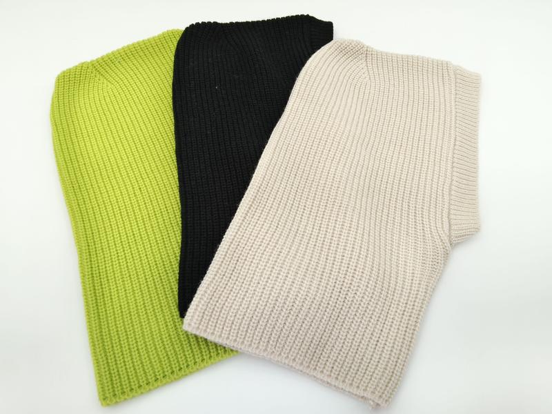 Three folded chunky ribbed knit sleeveless vest tops in lime green, black, and beige laid on white background - email us get price list now