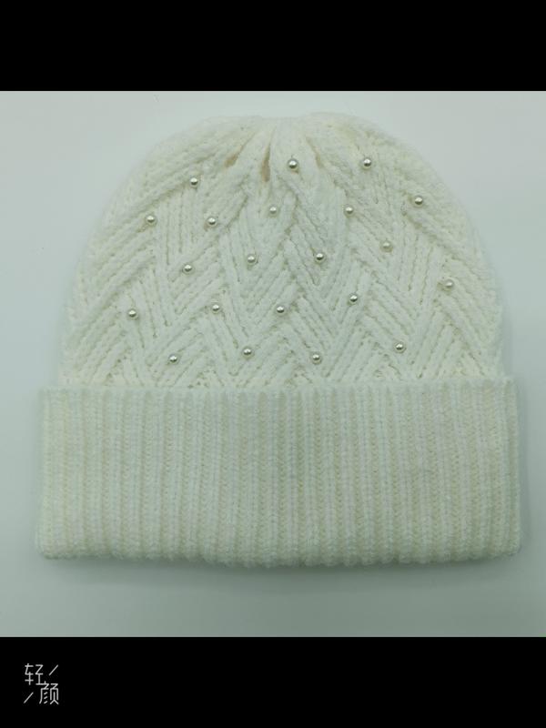 Cream white chunky knit winter beanie hat with herringbone pattern and scattered pearl bead decorations on flat surface - no MOQ for stock designs