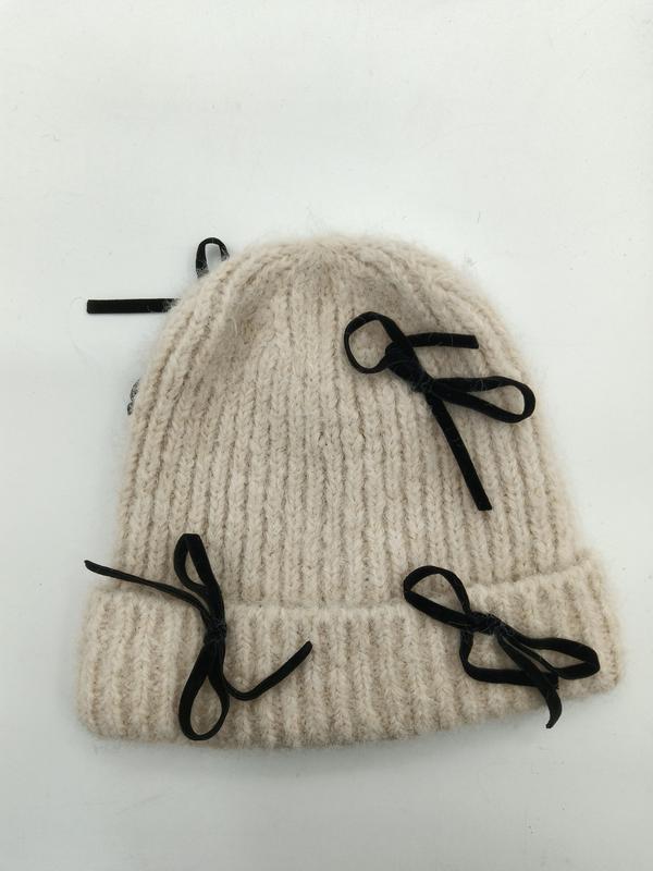 Cream chunky ribbed knit winter beanie hat with multiple black velvet ribbon bow embellishments on white background - retail buyer inquiry welcome - jacquard custom pattern accepted