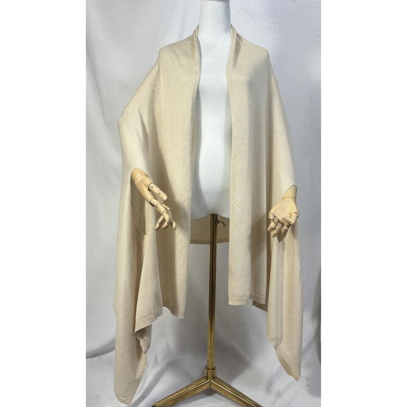 Cream fine knit open-front wrap ruana shawl with ribbed hem trim displayed on a dress form mannequin - boutique retail bulk order