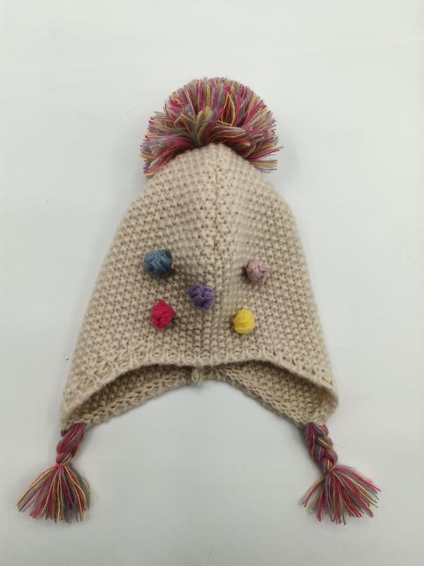 Cream knitted baby earflap hat with large multicolor pompom on top, colorful mini pompom accents, and braided tassel ties - bulk order 500+ pcs extra 8% off