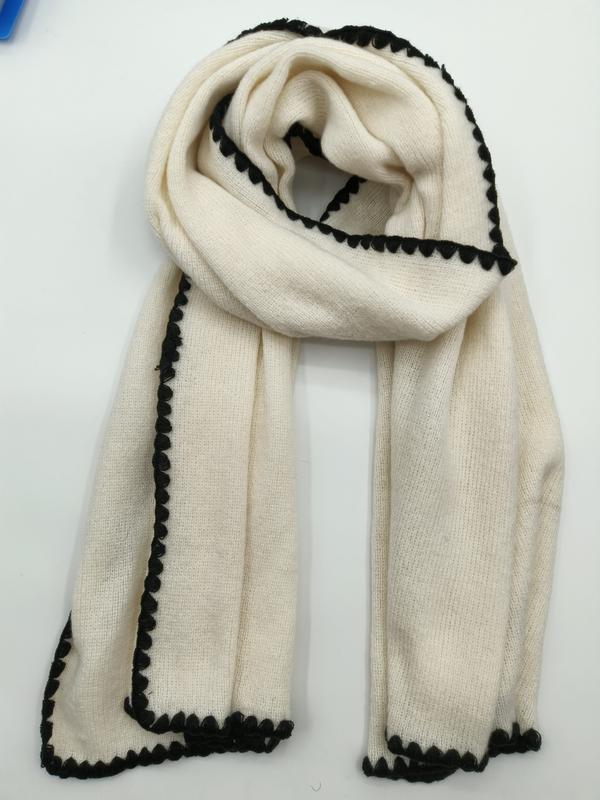 Cream ivory knitted scarf with decorative black scalloped border trim, folded and laid flat on white background - ask bulk pricing get discount
