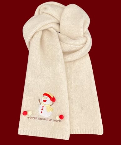 Soft cream knitted scarf folded with embroidered snowman design and red pom-pom accents on dark red background - contact for custom design quote